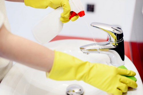 Technician using cleaning products safely during carpet care
